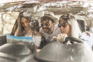 friends-travelling-car-looking-map